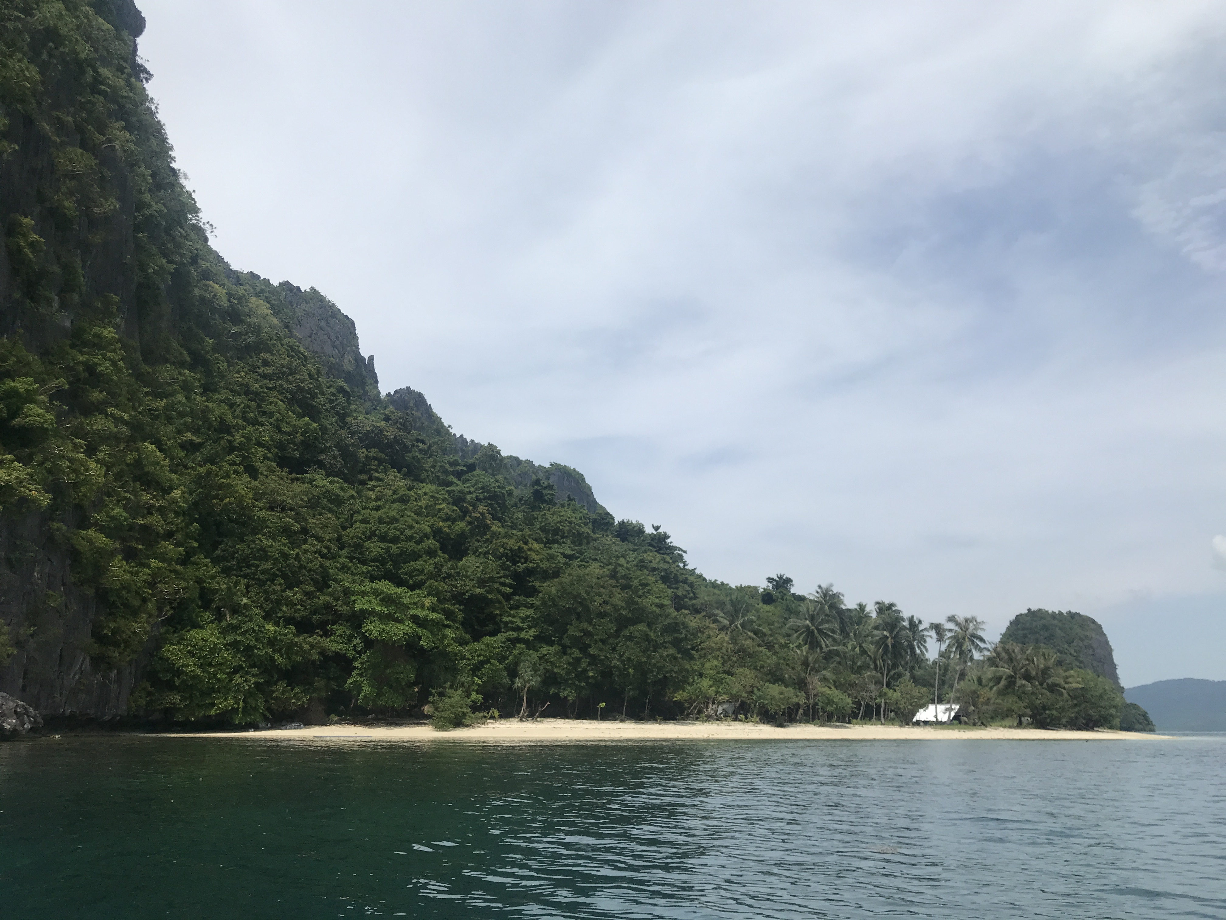 Malapacao Island — beach and cliffs from water